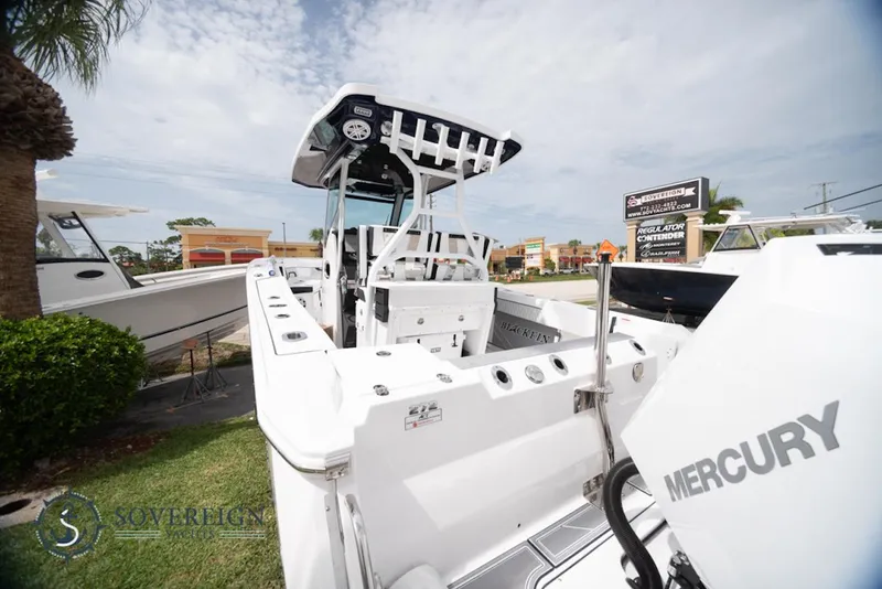 Slide: The Image of 2024 Blackfin 272 CC boat with Mercury engine, displayed outdoors. - 7