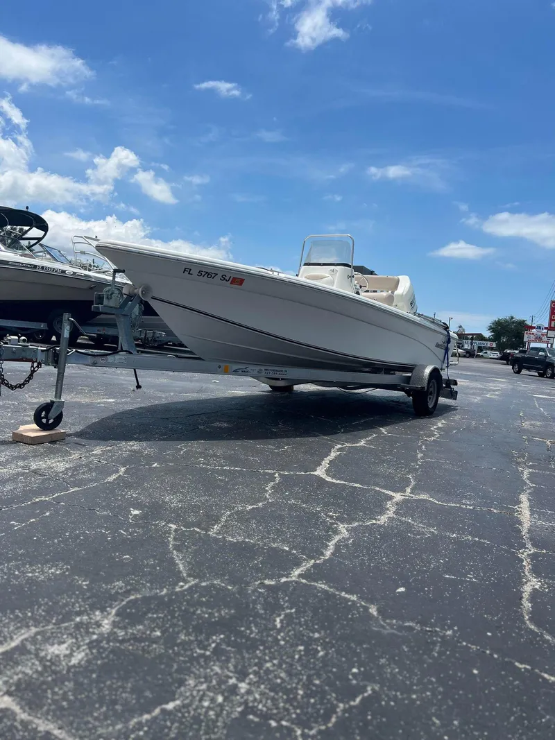 Slide: The Image of 2015 NauticStar 2110 Sport boat on trailer under clear blue sky. - 0