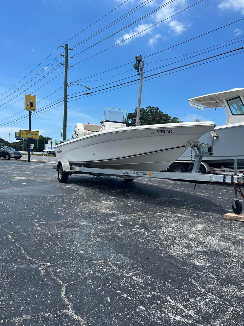 Slide: The Image of 2015 NauticStar 2110 Sport boat on trailer in parking lot. - 1