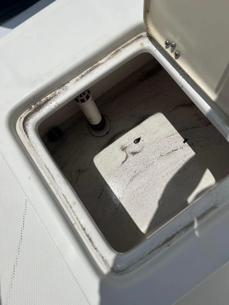 Slide: The Image of Open storage compartment on 2015 NauticStar 2110 Sport boat. - 12