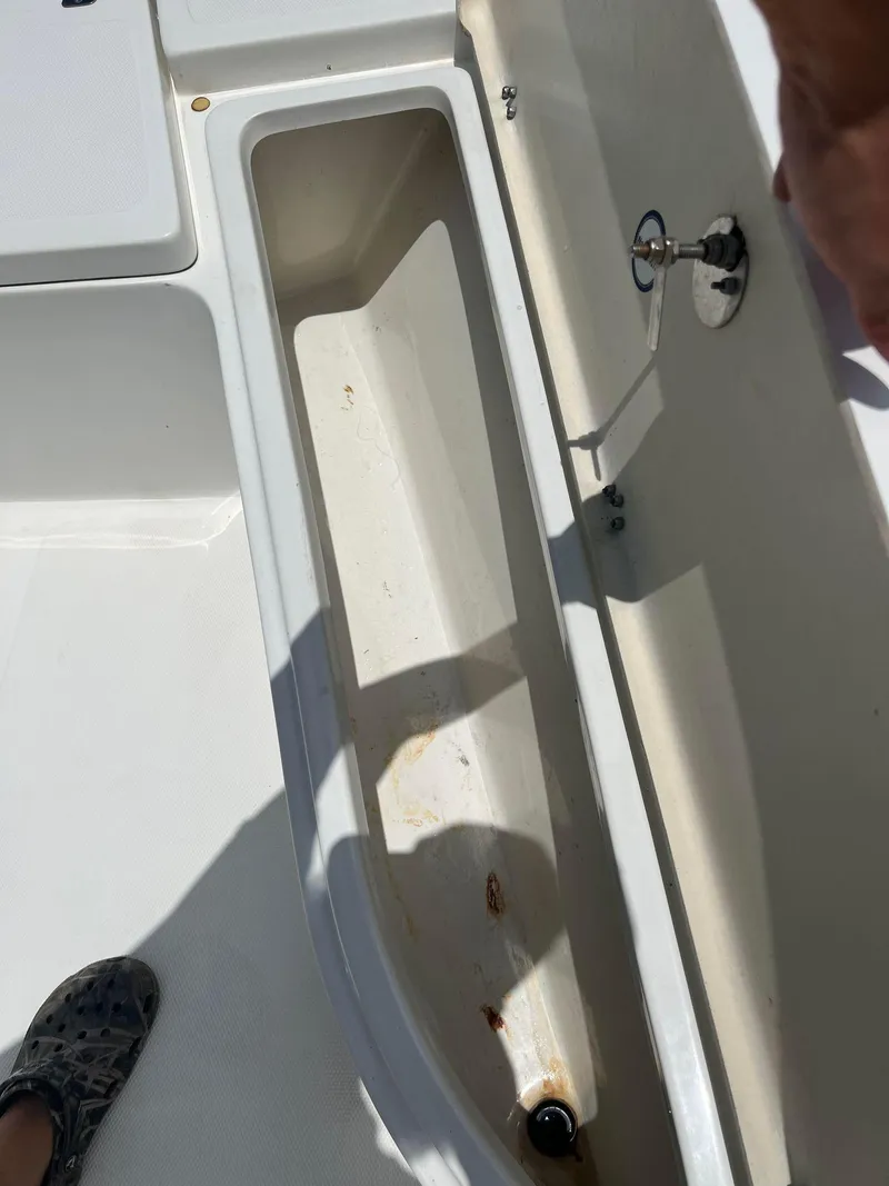 Slide: The Image of Open storage compartment on 2015 NauticStar 2110 Sport boat deck. - 15