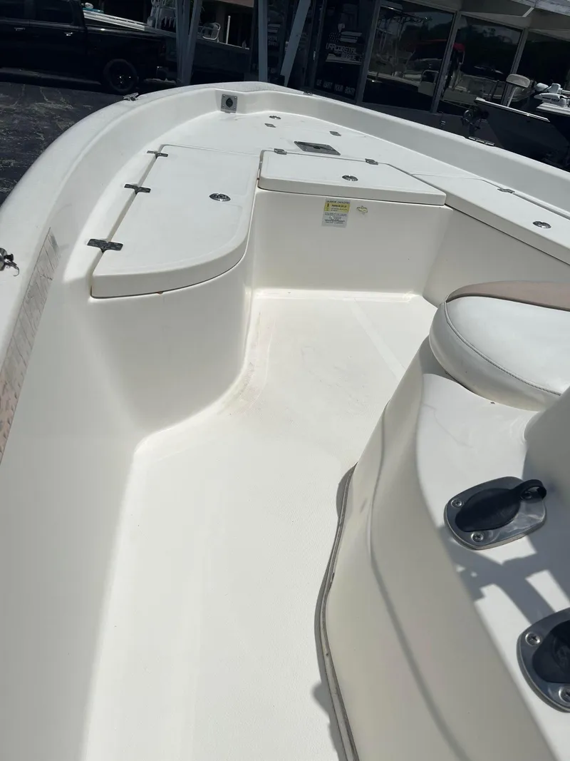 Slide: The Image of 2015 NauticStar 2110 Sport boat interior with seating and storage compartments. - 18