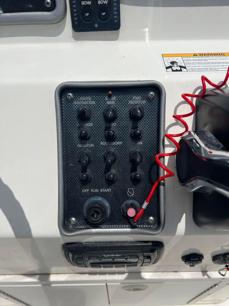 Slide: The Image of Control panel of 2015 NauticStar 2110 Sport boat with switches and safety lanyard. - 19