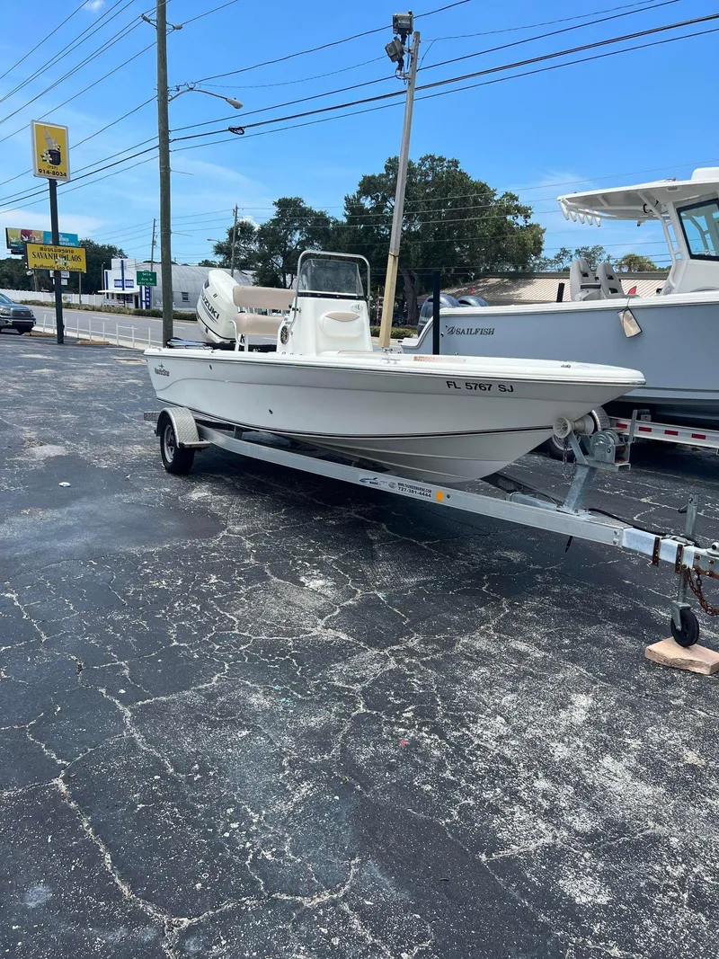 Slide: The Image of 2015 NauticStar 2110 Sport boat on trailer in parking lot. - 2