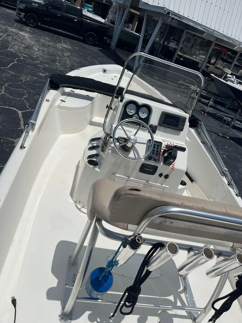 Slide: The Image of 2015 NauticStar 2110 Sport boat interior with steering console and seating. - 20