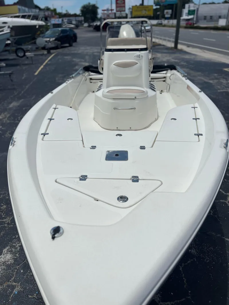 Slide: The Image of 2015 NauticStar 2110 Sport boat, white, parked on pavement, front view. - 6