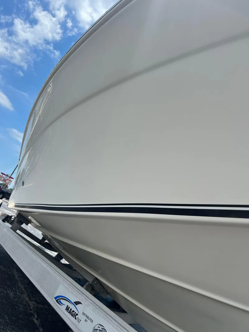 Slide: The Image of 2015 NauticStar 2110 Sport boat on trailer under blue sky. - 7