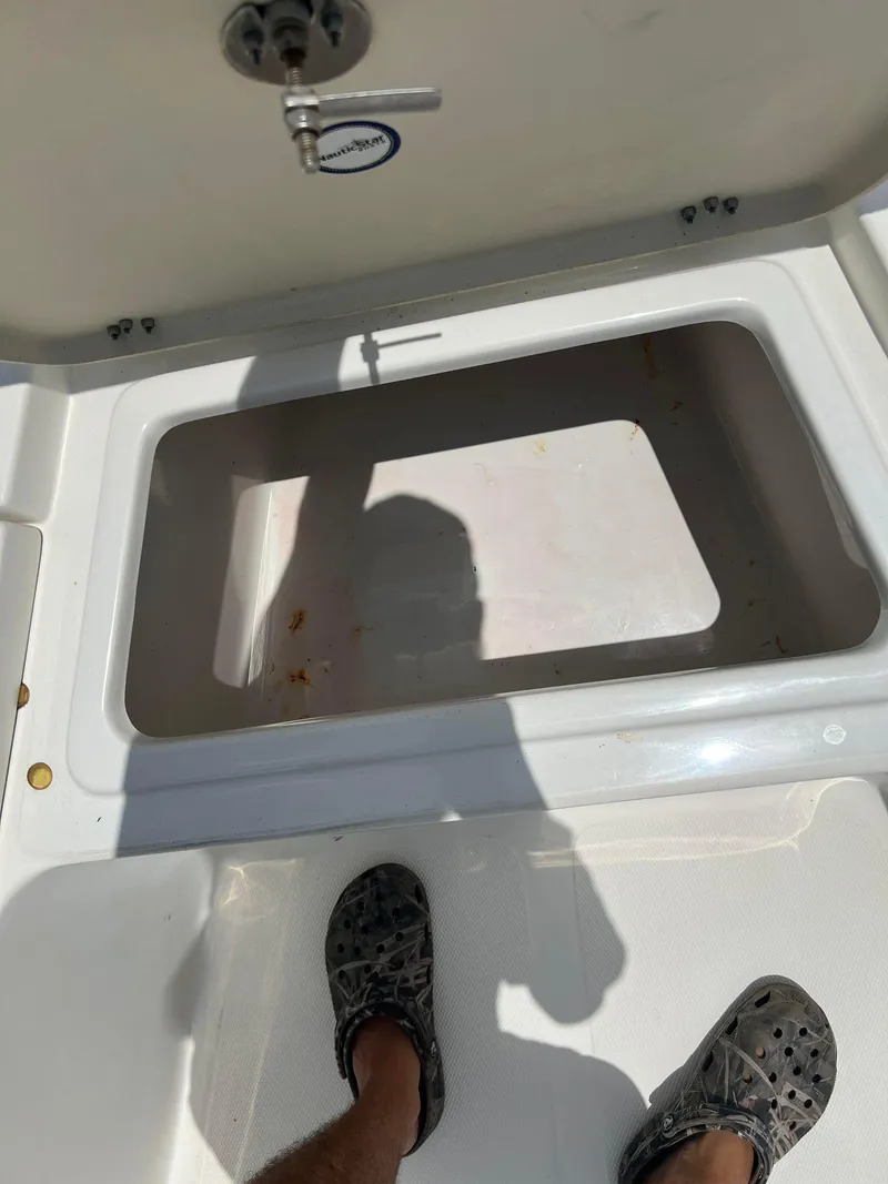 Slide: The Image of Open storage compartment on 2015 NauticStar 2110 Sport boat. - 9