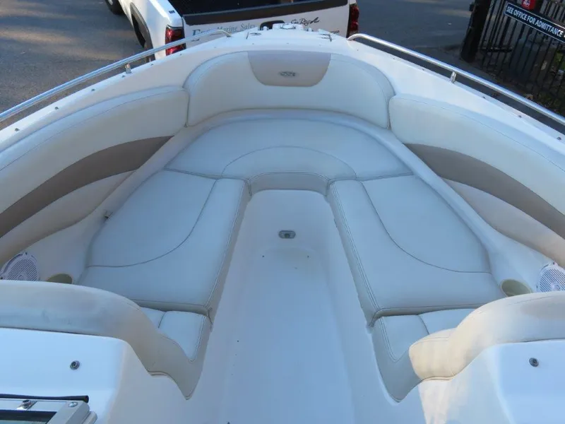 Slide: The Image of 2004 Chaparral 256 SSi boat interior with white cushioned seating. - 10