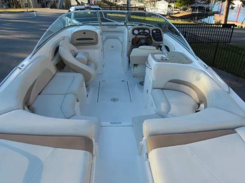 Slide: The Image of 2004 Chaparral 256 SSi boat interior with spacious seating and modern dashboard. - 3
