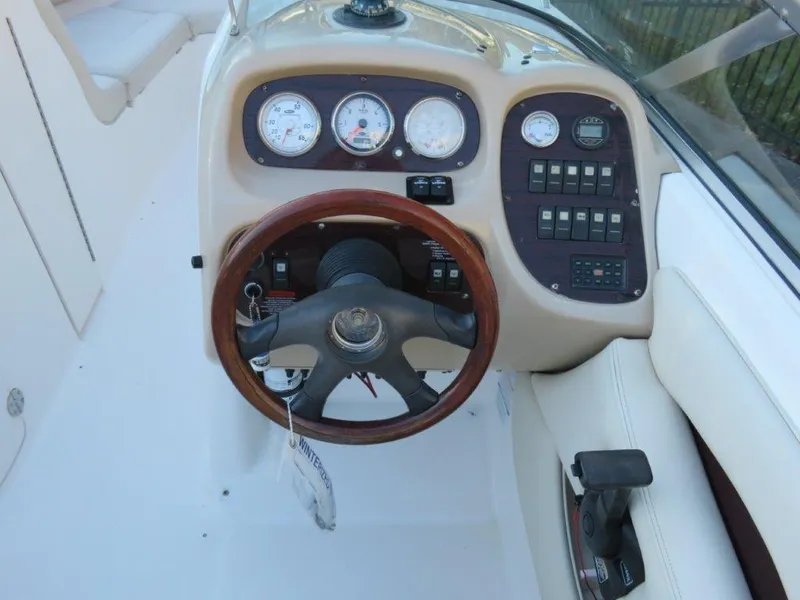 Slide: The Image of 2004 Chaparral 256 SSi boat dashboard with gauges, steering wheel, and control panel. - 6