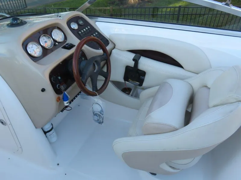Slide: The Image of 2004 Chaparral 256 SSi boat cockpit with steering wheel and gauges. - 7