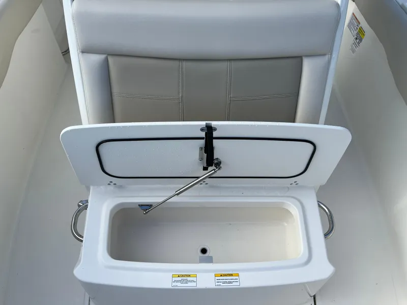 Slide: The Image of 2024 Boston Whaler 230 Outrage boat seat with storage compartment open. - 15