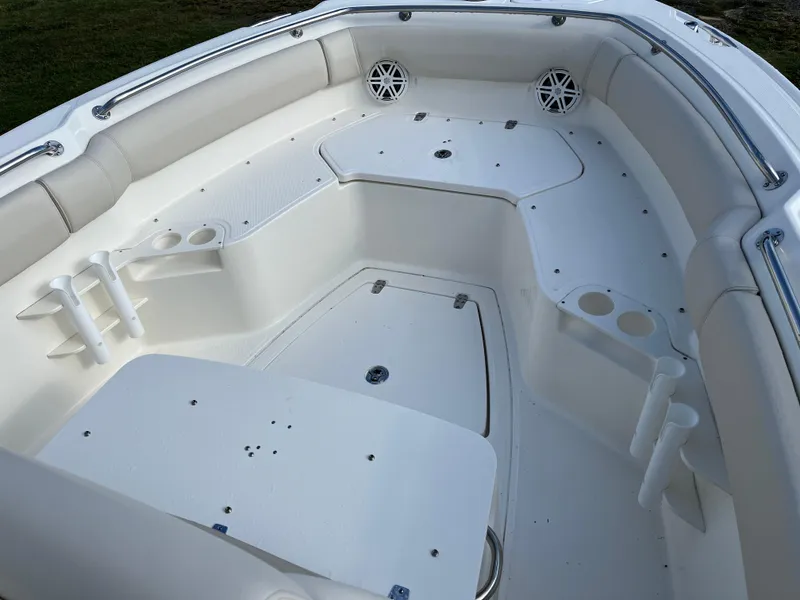 Slide: The Image of 2024 Boston Whaler 230 Outrage boat interior with seating and cup holders. - 18