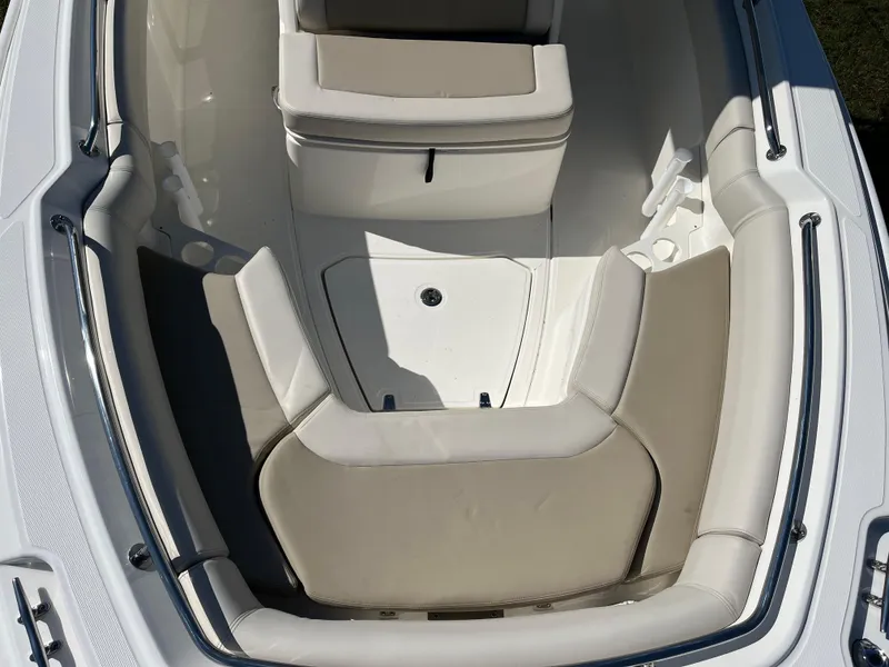 Slide: The Image of 2024 Boston Whaler 230 Outrage boat interior with cushioned seating and storage. - 21