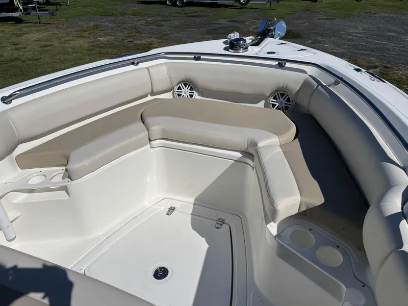 Slide: The Image of 2024 Boston Whaler 230 Outrage boat interior with cushioned seating and cup holders. - 25