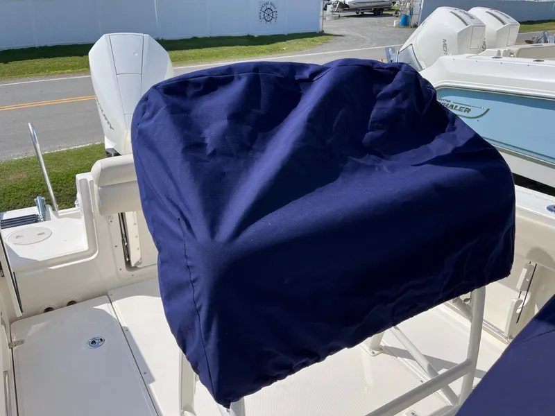 Slide: The Image of 2024 Boston Whaler 230 Outrage boat with covered seating area, showcasing modern design. - 30