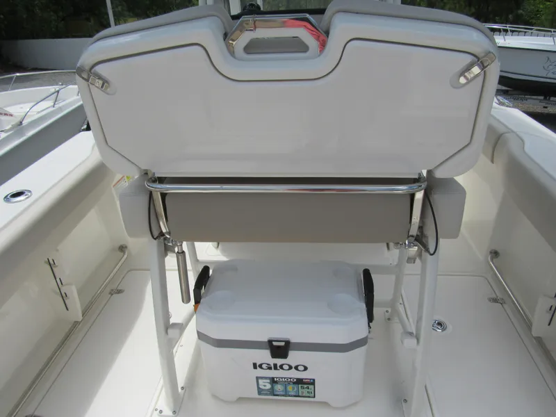 Slide: The Image of Boston Whaler 230 Outrage 2024 boat with Igloo cooler in storage compartment. - 8