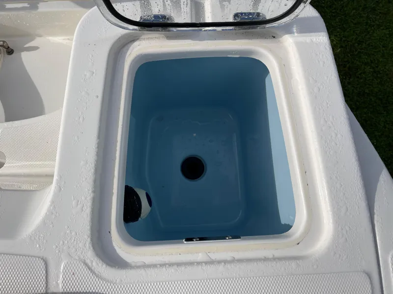 Slide: The Image of Livewell compartment on 2024 Boston Whaler 230 Outrage boat, open lid view. - 9