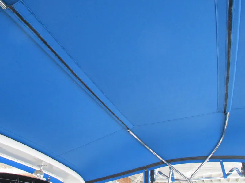 Slide: The Image of Blue canopy of 1988 Vista 49 Motor Yacht, featuring sleek metal supports. - 38