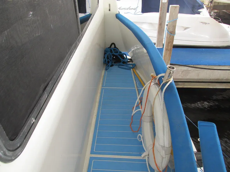 Slide: The Image of 1988 Vista 49 Motor Yacht deck with blue flooring and safety equipment. - 41