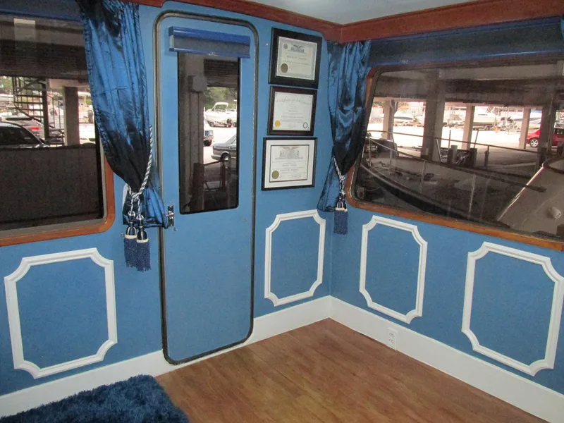 Slide: The Image of Interior of 1988 Vista 49 Motor Yacht with blue decor and framed certificates. - 43