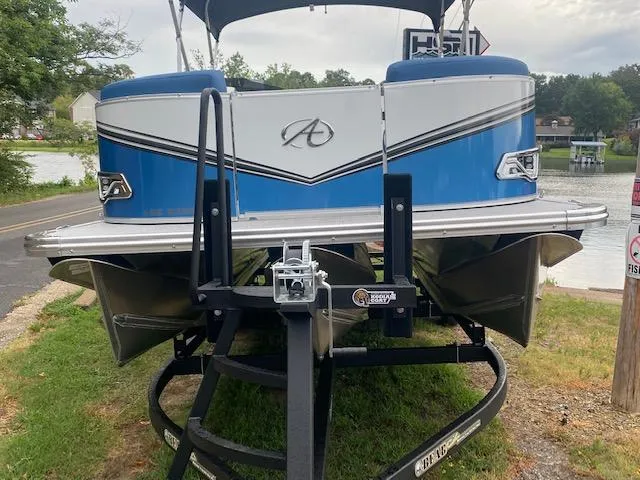 Slide: The Image of 2024 Avalon LSZ 2385 VRL pontoon boat on trailer by a lake. - 11