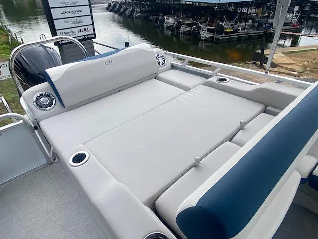 Slide: The Image of 2024 Avalon LSZ 2385 VRL boat with spacious seating and cup holders by the water. - 16