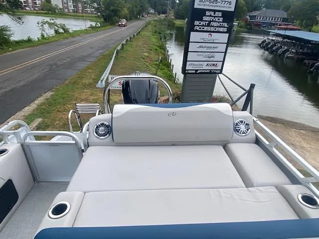 Slide: The Image of 2024 Avalon LSZ 2385 VRL pontoon boat with spacious seating by a riverside. - 20