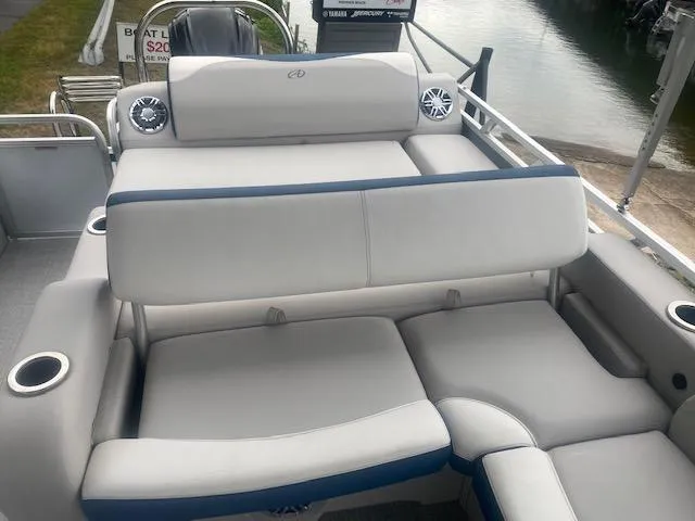 Slide: The Image of 2024 Avalon LSZ 2385 VRL boat with comfortable seating and cup holders by the water. - 23