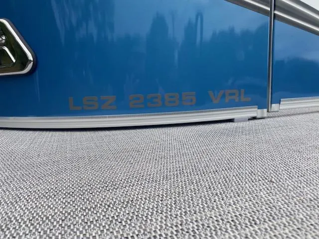 Slide: The Image of 2024 Avalon LSZ 2385 VRL boat model name on blue exterior. - 6