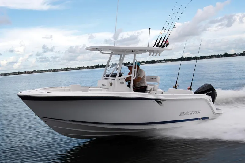 Slide: The Image of 2024 Blackfin 222 CC boat interior with white quilted seating and sleek design. - 3