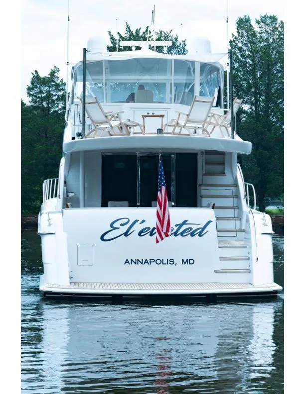 Slide: The Image of 2006 Hatteras 64 Motor Yacht docked, displaying American flag, Annapolis, MD. - 11