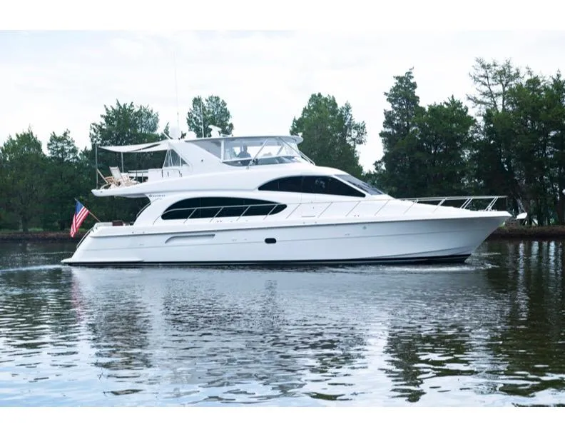 Slide: The Image of 2006 Hatteras 64 Motor Yacht cruising on a serene lake. - 12