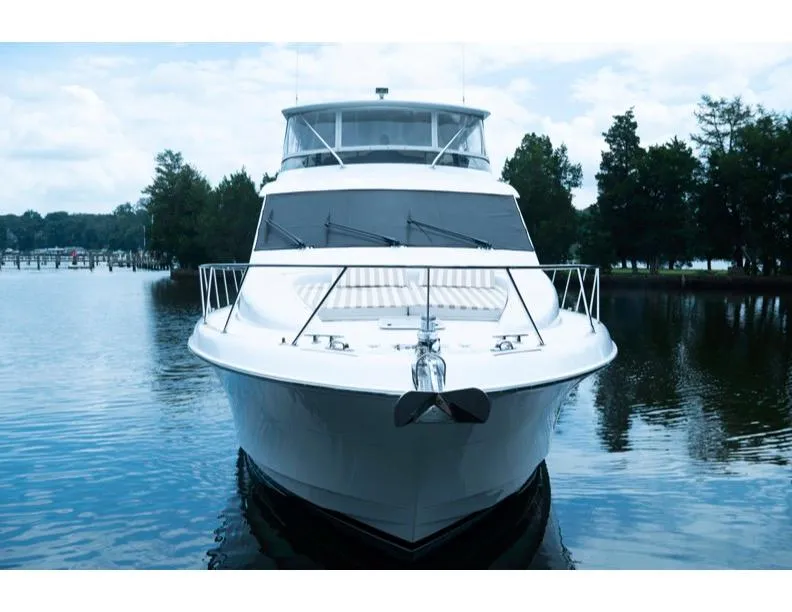 Slide: The Image of 2006 Hatteras 64 Motor Yacht on calm water, front view. - 14
