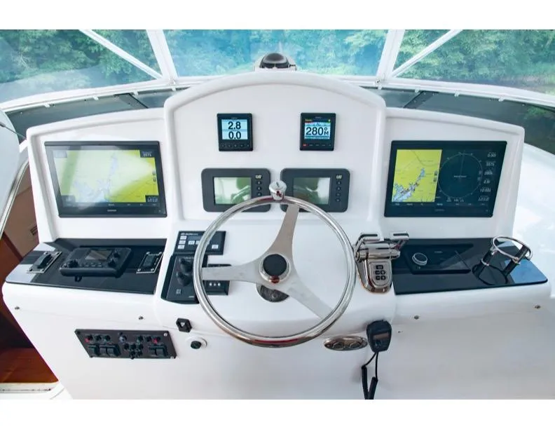 Slide: The Image of Helm of 2006 Hatteras 64 Motor Yacht with navigation displays and controls. - 22