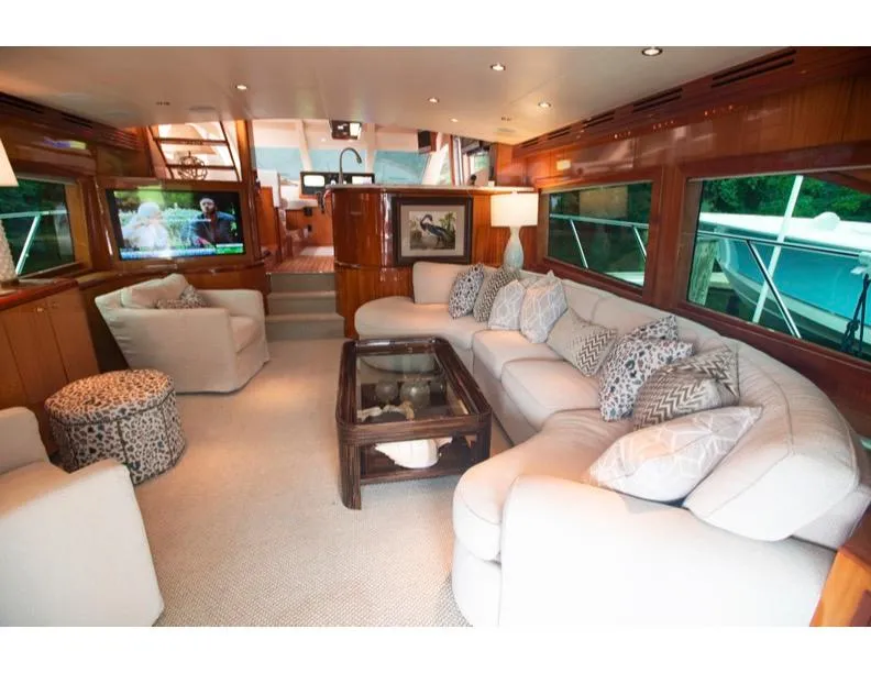 Slide: The Image of Luxurious interior of 2006 Hatteras 64 Motor Yacht with plush seating and elegant decor. - 26