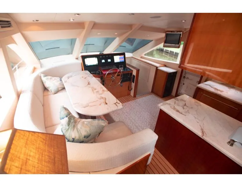 Slide: The Image of Luxurious 2006 Hatteras 64 Motor Yacht interior with elegant seating and navigation area. - 28