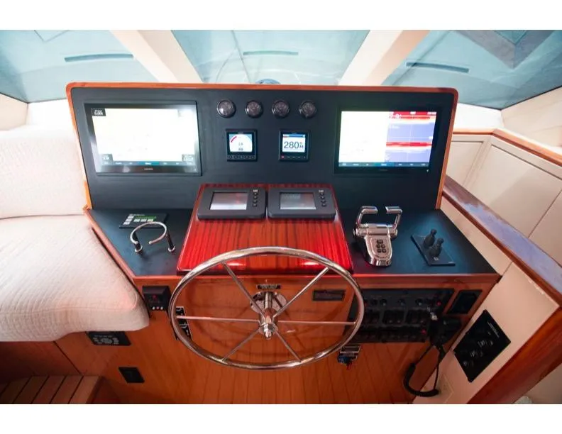 Slide: The Image of Helm of 2006 Hatteras 64 Motor Yacht with navigation screens and controls. - 31