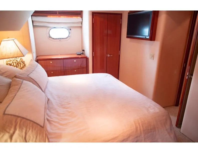 Slide: The Image of Luxurious bedroom interior of 2006 Hatteras 64 Motor Yacht with elegant furnishings. - 40