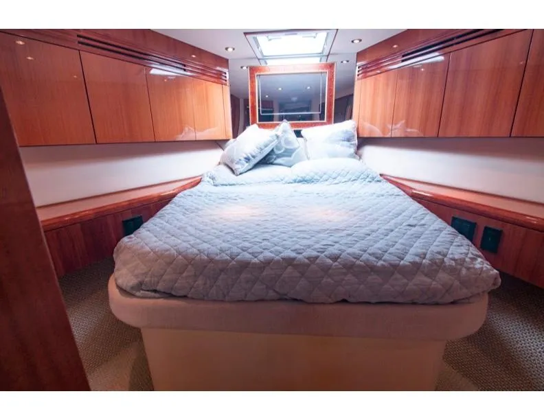Slide: The Image of Luxurious bedroom interior of 2006 Hatteras 64 Motor Yacht with elegant wood finishes. - 42