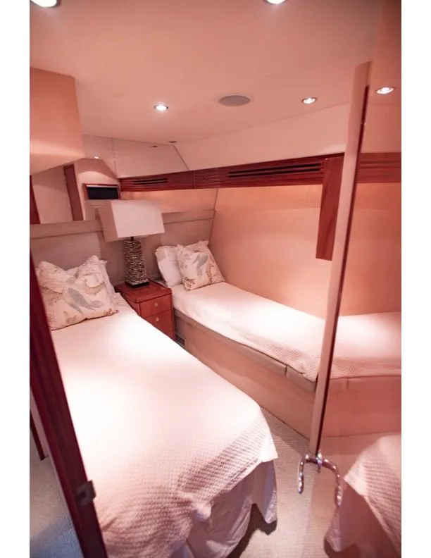 Slide: The Image of 2006 Hatteras 64 Motor Yacht twin bedroom with elegant decor and soft lighting. - 46