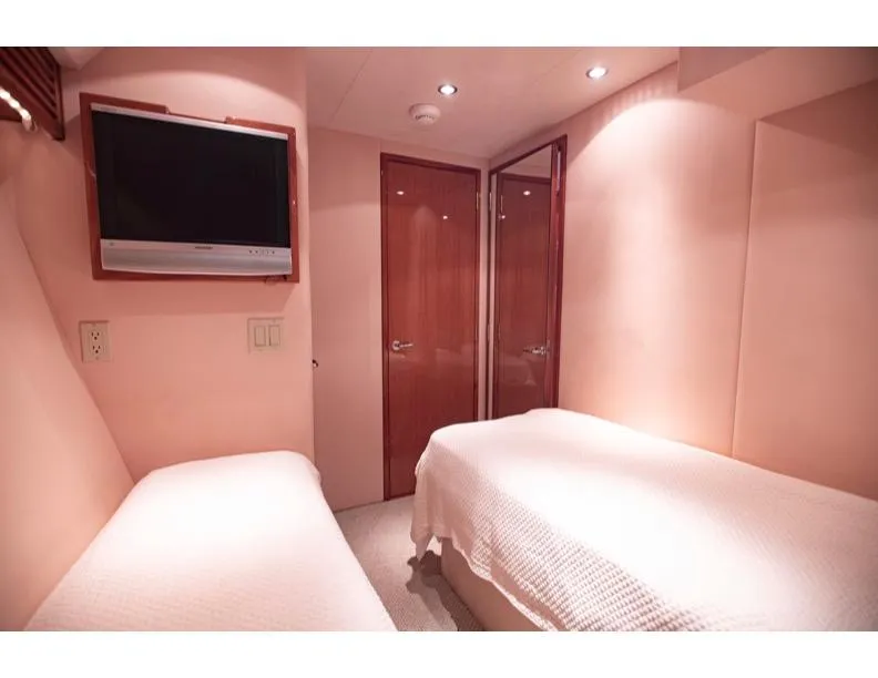 Slide: The Image of Interior of 2006 Hatteras 64 Motor Yacht with twin beds and wall-mounted TV. - 47