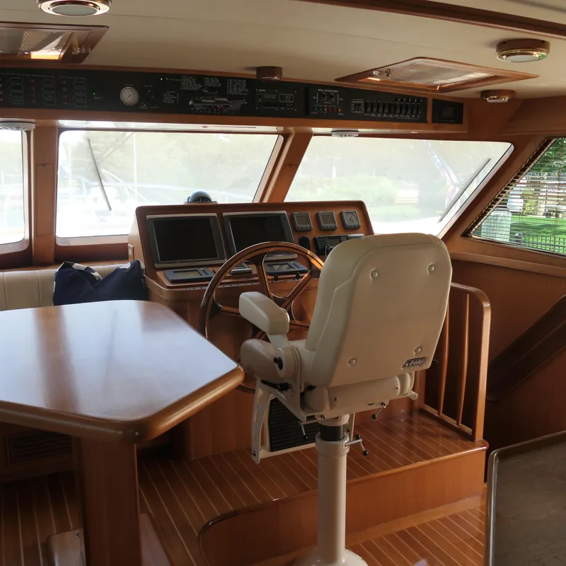 Slide: The Image of Interior of 2008 Marlow 53 C Explorer yacht with helm, steering wheel, and navigation equipment. - 10