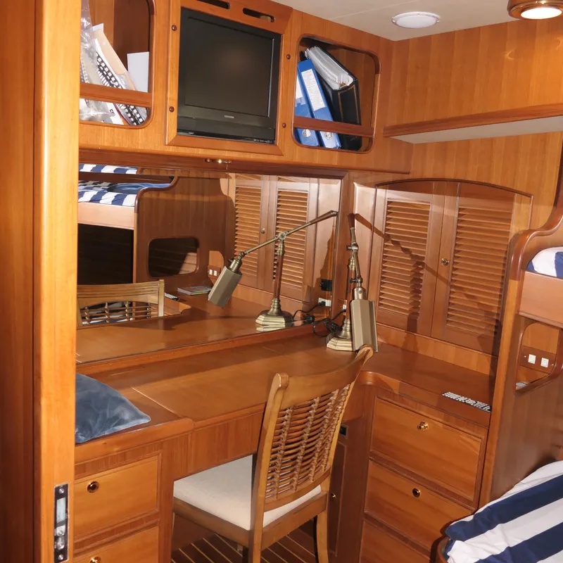 Slide: The Image of Interior of 2008 Marlow 53 C Explorer yacht with wooden cabinetry and desk. - 13