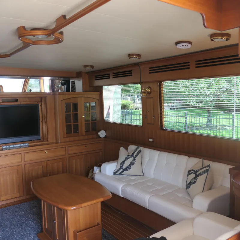 Slide: The Image of Luxurious interior of 2008 Marlow 53 C Explorer yacht with wood paneling and white seating. - 4