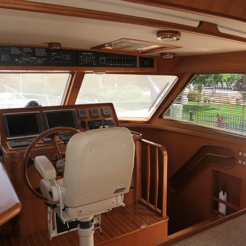 Slide: The Image of 2008 Marlow 53 C Explorer yacht helm with wooden interior and navigation equipment. - 9