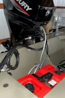 Slide: The Image of 2024 Tracker Grizzly 1648 SC boat with Mercury outboard motor and red fuel tank. - 4