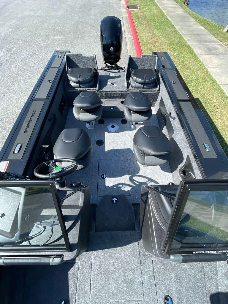 Slide: The Image of 2024 Tracker Targa V-18 Combo fishing boat interior with seating and motor. - 3