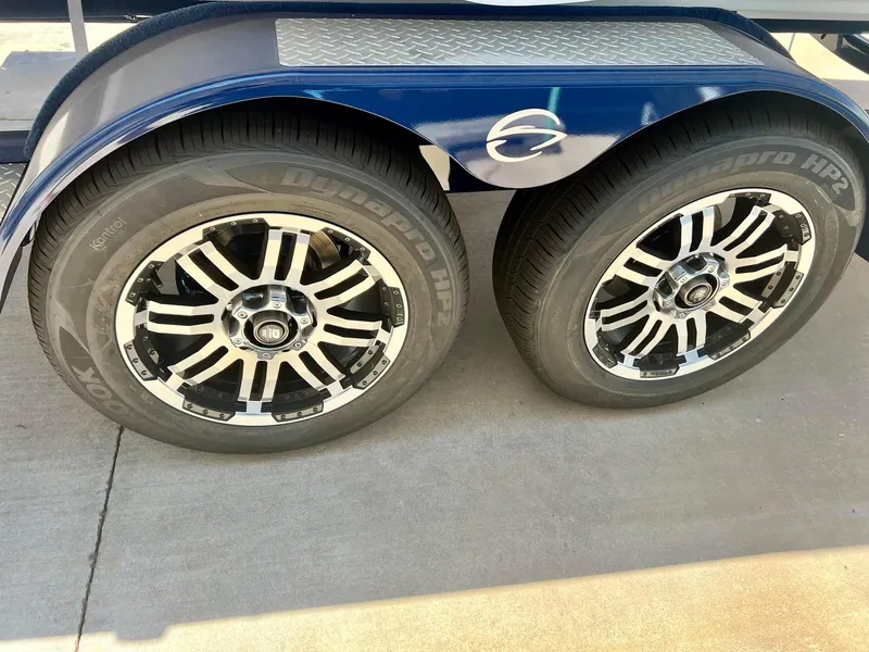 Slide: The Image of 2024 Crownline 270SS trailer wheels with stylish black and silver rims. - 10